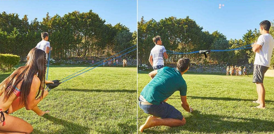 mensen spelen buiten in de tuin met een waterballonnen katapult